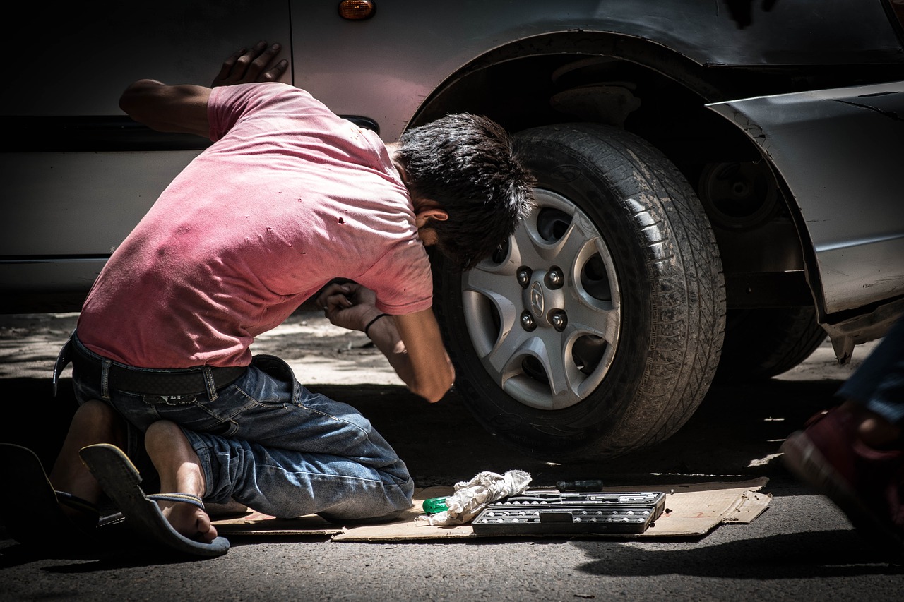 kid fixing a car