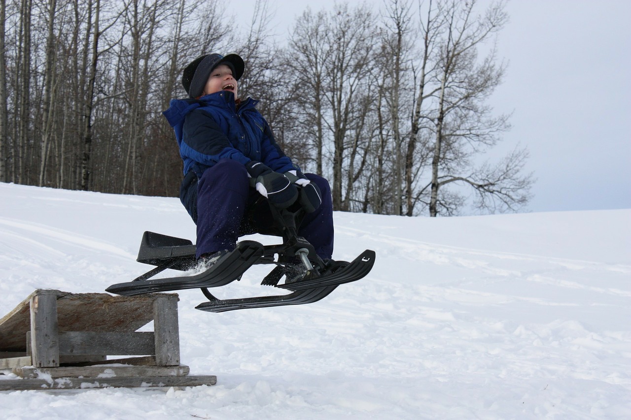 Montreal winter activities, boy riding sleigh