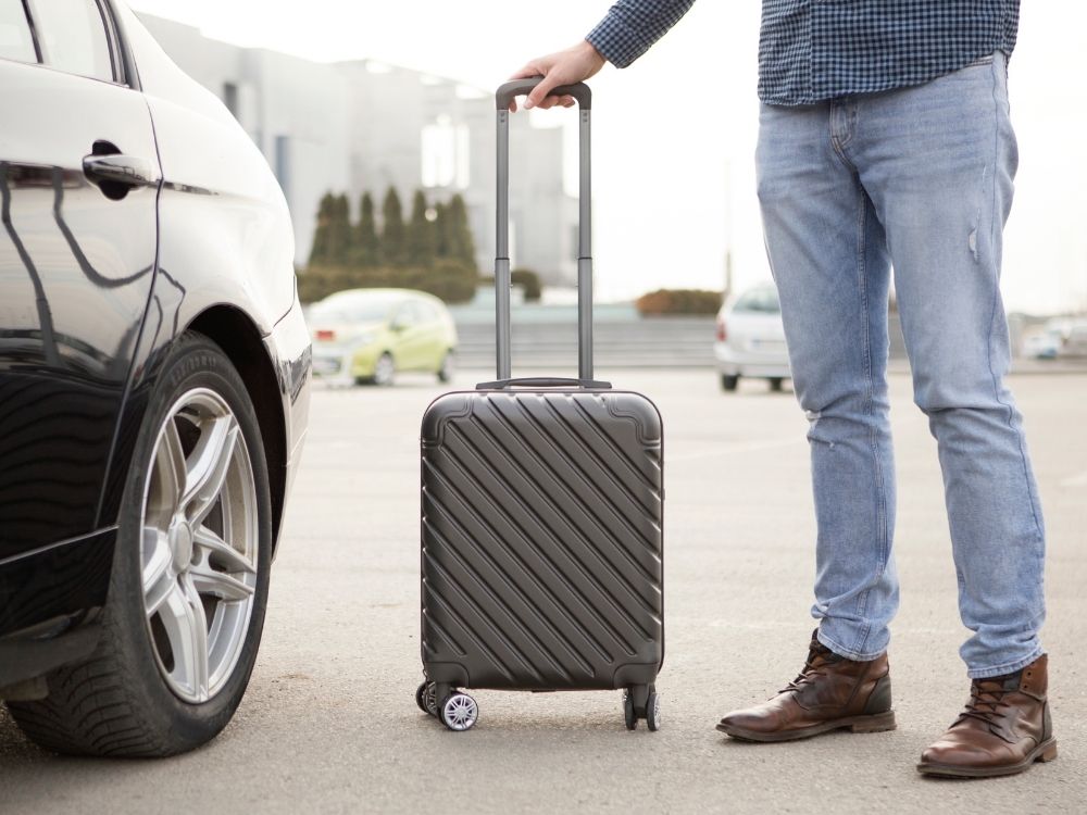 man with suitcase, rent a car in dubai