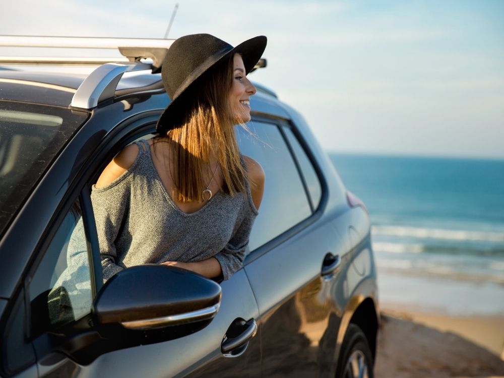 rental cars in curacao, beach, woman in rental car