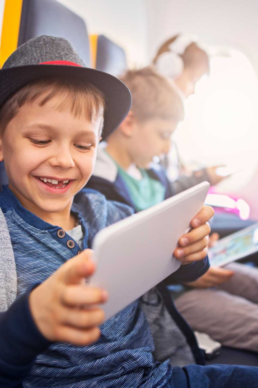 kids with tablets on a flight, long flight tips