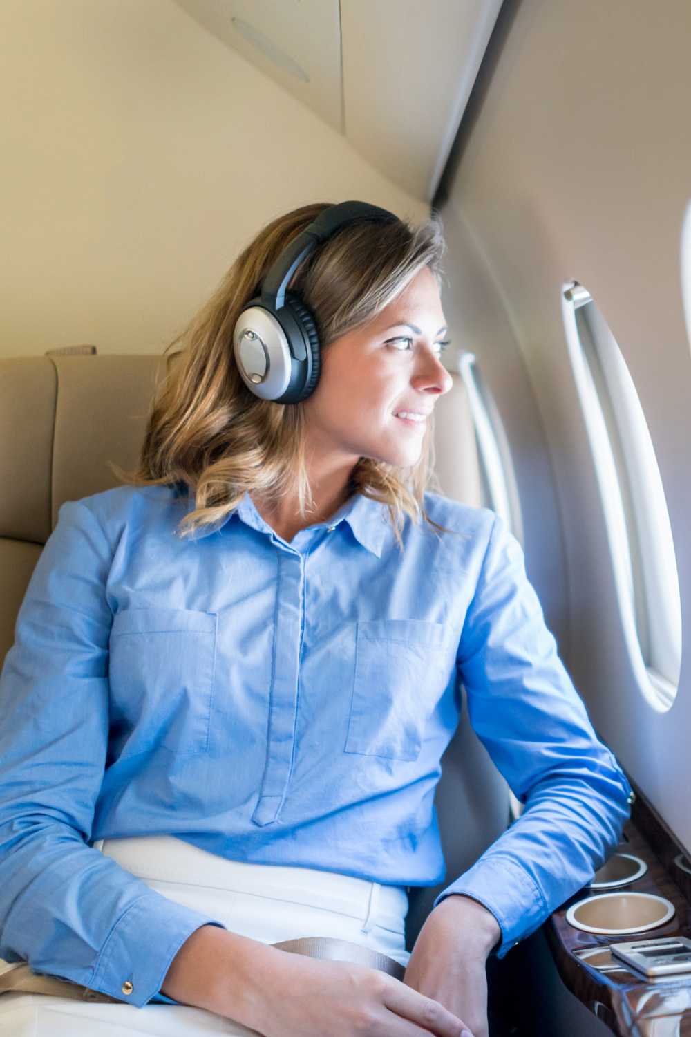 woman with headphones on a flight, long flight tips