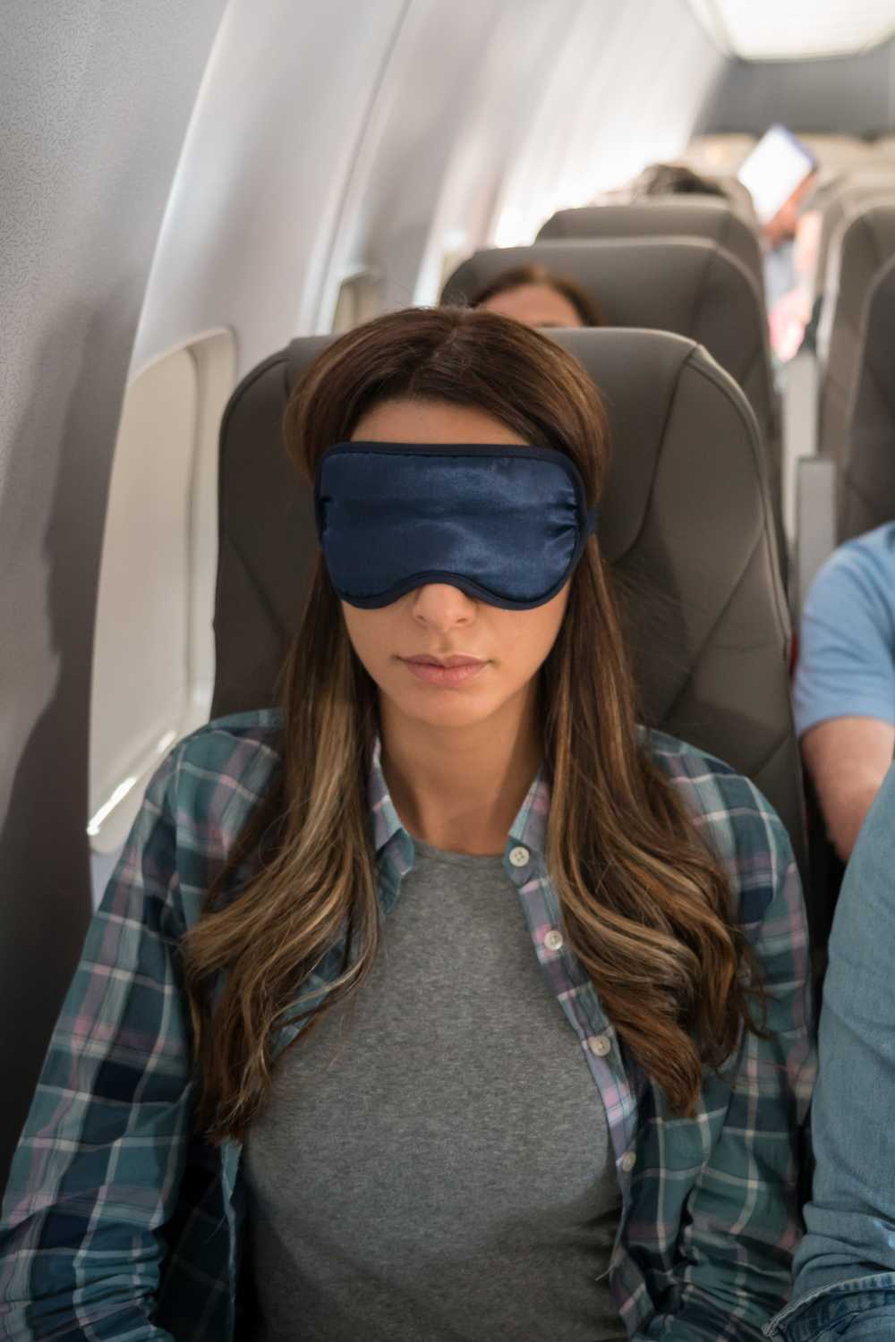 woman sleeping on flight, long flight tips